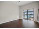 Spacious living room with hardwood floors, light grey paint, and sliding glass door with pool views at 5104 E Longboat Blvd, Tampa, FL 33615