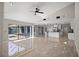 Open concept living space with access to kitchen, large tile floors, and views of screened in lanai at 5104 E Longboat Blvd, Tampa, FL 33615