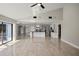 Open-concept living space with tile floors, modern lighting, and a seamless flow into the kitchen at 5104 E Longboat Blvd, Tampa, FL 33615