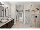 Elegant bathroom with double vanities, glass shower, and direct access to outdoor spaces at 5104 E Longboat Blvd, Tampa, FL 33615
