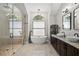 Serene bathroom featuring a glass-enclosed shower, soaking tub, and stylish fixtures at 5104 E Longboat Blvd, Tampa, FL 33615