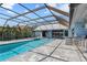 A screened pool with an outdoor kitchen is perfect for entertaining at 5104 E Longboat Blvd, Tampa, FL 33615