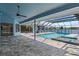 A view of the covered and screened pool area with outdoor kitchen and view of the canal at 5104 E Longboat Blvd, Tampa, FL 33615