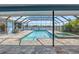 Screened pool and spa with an outdoor kitchen and serene waterfront views at 5104 E Longboat Blvd, Tampa, FL 33615