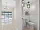 View of the powder room adjacent to the living room, featuring a pendant light at 5104 E Longboat Blvd, Tampa, FL 33615