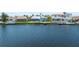Waterfront view of the house, neighboring properties, and private docks, perfect for boaters at 5104 E Longboat Blvd, Tampa, FL 33615