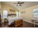 Comfortable bedroom with hardwood floors, a ceiling fan, and large windows at 632 Lake Cypress Cir, Oldsmar, FL 34677
