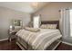 Cozy bedroom with dark hardwood floors, chandelier and matching vanity at 632 Lake Cypress Cir, Oldsmar, FL 34677