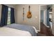 Bedroom with wood floors, blue accents, and a view into the hall from the open bedroom door at 632 Lake Cypress Cir, Oldsmar, FL 34677