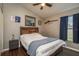 Bedroom featuring modern decor, wood flooring, a ceiling fan, and large windows with privacy blinds at 632 Lake Cypress Cir, Oldsmar, FL 34677