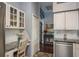Well-organized kitchen featuring a granite counter desk, white cabinets, and stainless-steel appliances at 632 Lake Cypress Cir, Oldsmar, FL 34677