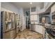 Spacious kitchen boasts stainless steel appliances, granite countertops, and tiled floors at 632 Lake Cypress Cir, Oldsmar, FL 34677