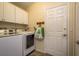 Laundry room with white cabinets and newer washing machines at 632 Lake Cypress Cir, Oldsmar, FL 34677