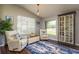 Cozy living room with hardwood floors, armchairs, and plenty of natural light at 632 Lake Cypress Cir, Oldsmar, FL 34677