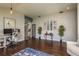 Open-concept living area featuring hardwood floors, an office setup, and stylish decor at 632 Lake Cypress Cir, Oldsmar, FL 34677