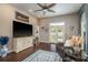 Comfortable living room with hardwood floors, a large television, and access to the pool at 632 Lake Cypress Cir, Oldsmar, FL 34677