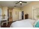Bright main bedroom with a ceiling fan, hardwood floors, and a view of the en-suite bathroom at 632 Lake Cypress Cir, Oldsmar, FL 34677