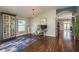 Stylish home office with dark wood floors, ample natural light, and a unique display cabinet at 632 Lake Cypress Cir, Oldsmar, FL 34677