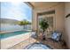 Cozy patio with comfortable chairs, a view of the pool, and tropical landscaping with privacy fencing at 632 Lake Cypress Cir, Oldsmar, FL 34677