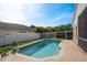 Backyard pool and patio with privacy fence and well-maintained landscaping create a private retreat at 632 Lake Cypress Cir, Oldsmar, FL 34677