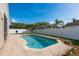 Backyard pool with a brick surround, clear blue water and lush landscaping at 632 Lake Cypress Cir, Oldsmar, FL 34677