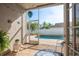 Enclosed patio showing views of the crystal-clear pool, manicured lawn, and tropical plants at 632 Lake Cypress Cir, Oldsmar, FL 34677