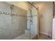 Modern walk-in shower with dual shower heads, a built-in seat, and decorative tile accents at 632 Lake Cypress Cir, Oldsmar, FL 34677