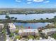 Beautiful aerial view of the building complex situated by the lake on a sunny day with lush greenery at 6475 Shoreline Dr # 5403, St Petersburg, FL 33708