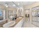 Bathroom showcasing dual sinks, granite countertops, and mirrored closet doors at 6475 Shoreline Dr # 5403, St Petersburg, FL 33708