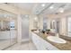 Bright bathroom featuring double sinks with granite counters and a glass enclosed shower at 6475 Shoreline Dr # 5403, St Petersburg, FL 33708