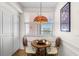 Charming breakfast nook illuminated by a colorful Tiffany-style lamp, creating a cozy dining space at 6475 Shoreline Dr # 5403, St Petersburg, FL 33708