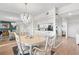 Dining room with a chandelier reflected in mirrored wall, adjacent to the updated kitchen at 6475 Shoreline Dr # 5403, St Petersburg, FL 33708