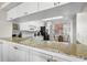 Open kitchen design with a breakfast bar, granite countertops, and white cabinets, perfect for entertaining at 6475 Shoreline Dr # 5403, St Petersburg, FL 33708