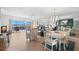 Expansive living room with balcony access and views; features neutral furniture and dining area at 6475 Shoreline Dr # 5403, St Petersburg, FL 33708