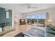 Open living room featuring a ceiling fan, nice flooring, and sliding glass doors to the screened balcony at 6475 Shoreline Dr # 5403, St Petersburg, FL 33708