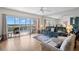 Bright living room with sliding glass doors leading to the screened balcony with gorgeous lake views at 6475 Shoreline Dr # 5403, St Petersburg, FL 33708