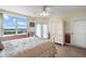 Light-filled main bedroom with view, comfy armchair, and ample storage in a built-in wardrobe at 6475 Shoreline Dr # 5403, St Petersburg, FL 33708