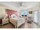 Bright main bedroom with a serene view, featuring a cozy armchair and light, airy decor at 6475 Shoreline Dr # 5403, St Petersburg, FL 33708