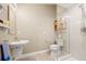Modern bathroom with glass enclosed shower, pedestal sink, and neutral color palette at 7201 15Th Ne Ct, St Petersburg, FL 33702