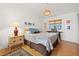 Comfortable bedroom features warm wood floors, a king-size bed, and stylish decor at 7201 15Th Ne Ct, St Petersburg, FL 33702