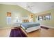 Well-lit bedroom with natural light, a vaulted ceiling, a ceiling fan, and neutral decor at 7201 15Th Ne Ct, St Petersburg, FL 33702
