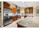 Stylish kitchen features stainless steel appliances, custom cabinets, granite countertops, and tile backsplash at 7201 15Th Ne Ct, St Petersburg, FL 33702
