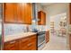 Modern kitchen featuring stainless steel appliances, granite countertops, and custom cabinetry at 7201 15Th Ne Ct, St Petersburg, FL 33702