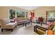 Bright living room showcasing tile floors, neutral furniture, and a cozy, inviting ambiance at 7201 15Th Ne Ct, St Petersburg, FL 33702