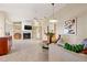Cozy living room featuring a fireplace, built-in shelving, and access to the kitchen at 7201 15Th Ne Ct, St Petersburg, FL 33702