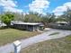 Ariel view showcases a charming home with a screened porch and a large driveway at 827 Louise St, Brandon, FL 33511