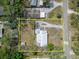 Aerial view of property showing lot lines, driveway, and surrounding greenery at 827 Louise St, Brandon, FL 33511