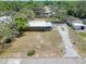 Aerial view of the property featuring a long drive and mature trees at 827 Louise St, Brandon, FL 33511