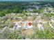 This aerial view highlights the home's location within a serene, tree-lined community with lush greenery at 827 Louise St, Brandon, FL 33511