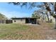 Large backyard with a shed, privacy fence, lawn, and mature trees at 827 Louise St, Brandon, FL 33511